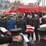 Sequim Gazette photo by Michael Dashiell / Firefighters pay tribute to Capt. Charles Chad Cate at a memorial service at Sequim High School on Jan. 21.