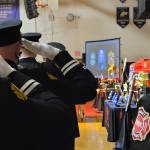 Sequim Gazette photo by Michael Dashiell / Firefighters pay tribute to Capt. Charles Chad Cate at a memorial service at Sequim High School on Jan. 21.