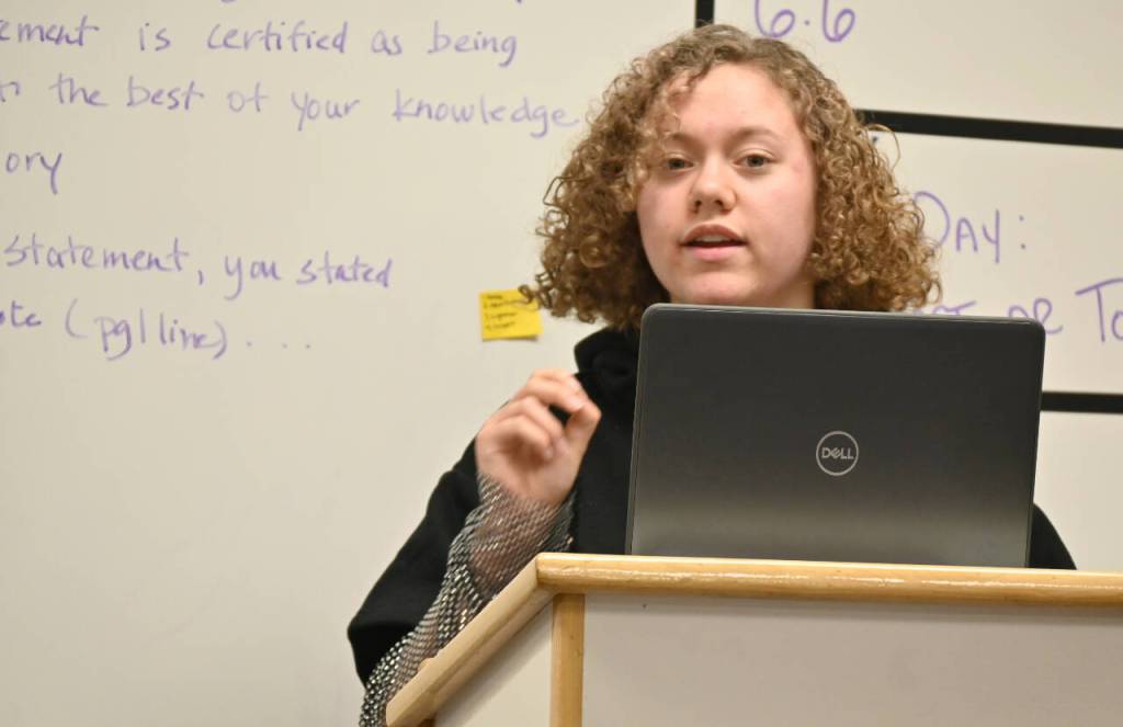 Sequim Gazette photo by Michael Dashiell / Grace Rogers works on her opening statement during a Mock Trial club practice last week.