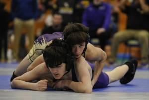 Sequims Cayden Beauregard, top right, takes on North Kitsaps Nolan Hancock at a sub-district tournament in Bremerton on Feb. 4. Beauregard won the match by technical fall (18-3) and took first place overall at 106 pounds.