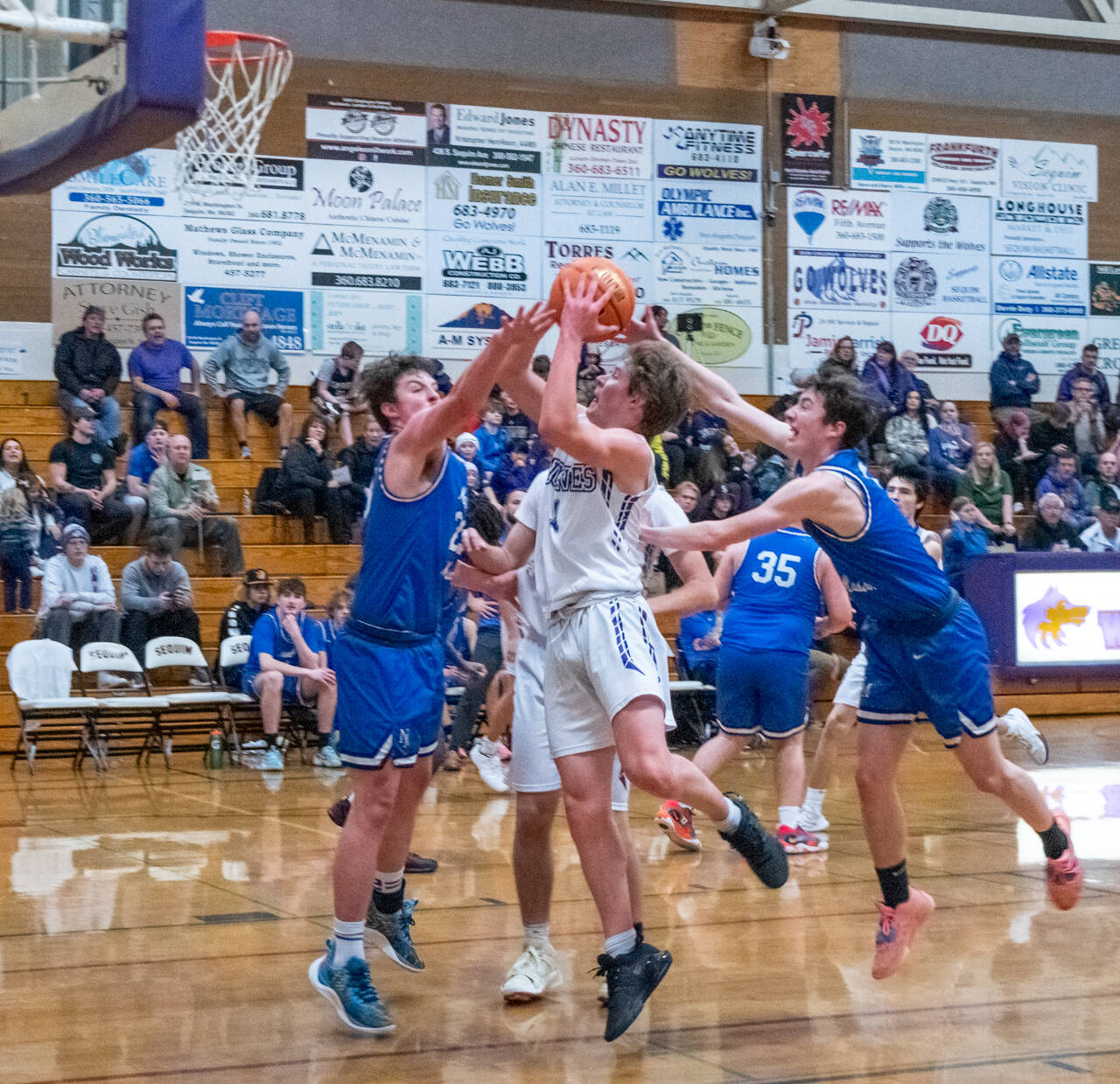 Sequim Gazette photos by Emily Matthiessen 
Sequim guard Zack Thompson, center, looks to score in a 64-44 Wolves win over North Mason on Jan. 24.