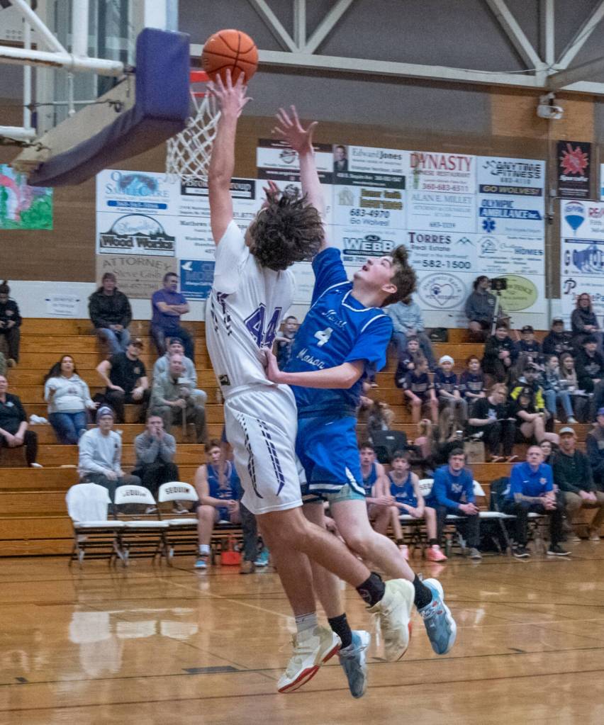 Sequim Gazette photo by Emily Matthiessen / Sequim's xxxxxx xxxxxxxx, left, looks to score as North Mason's Nolan McGanney guards the basket.