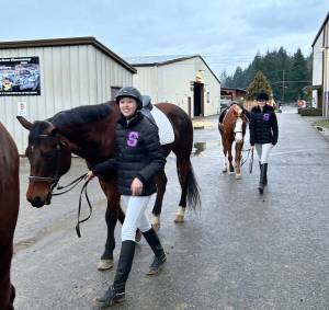 Katelynn Sharpe and Celbie Karjalainen prepare for the dressage competition at the first district meet of the season in Elma in late January.