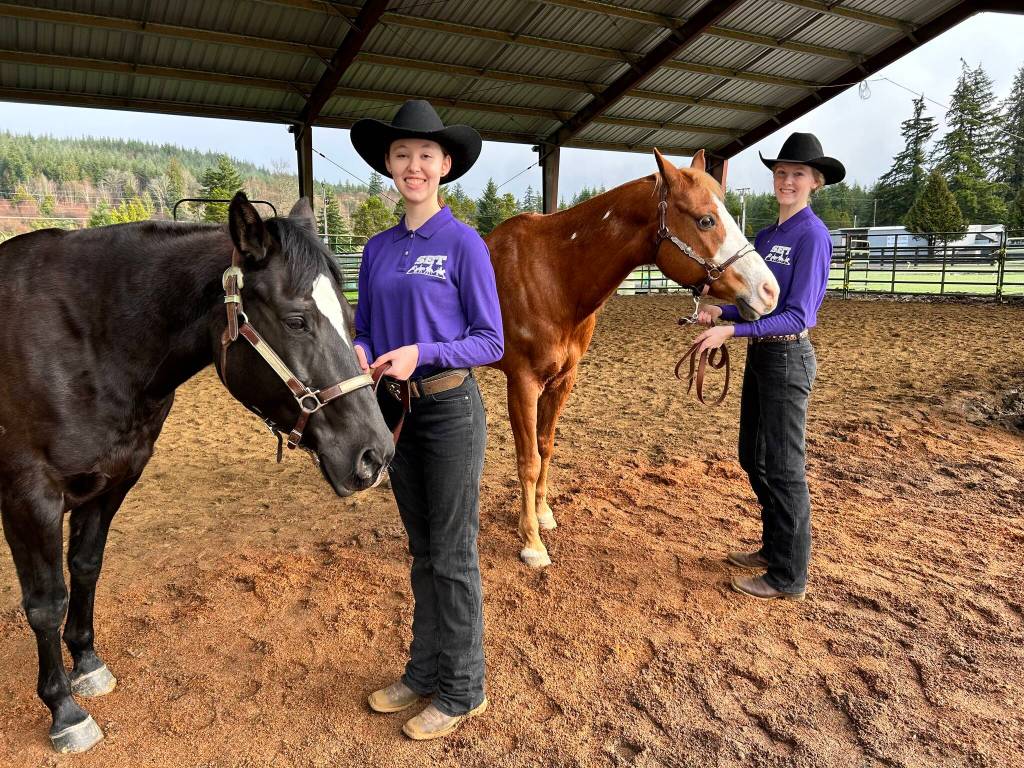 Submitted photo / Katelynn Sharpe, left, and Celbie Karjalainen compete in the showmanship event at the first district meet in Elma in late January.
