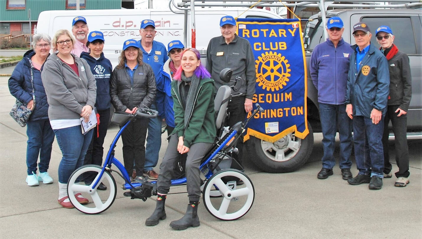 Submitted photo / Sequim Noon Rotary members present an adaptive tricycle to representatives from Camp Beausite Northwest last week. Pictured, from left, are Rotarian Judy Shanks; Camp Beausite Northwests executive director Raina Baker; Rotarians Stuart Dille, Mary Budke, Anna Richmond, Ted Shanks and Margot Hewitt; camp community development coordinator Tinna Barnet, and Rotarians Ren Garypie, Don Sorensen, Bob Macaulay and Kelly Macaulay.