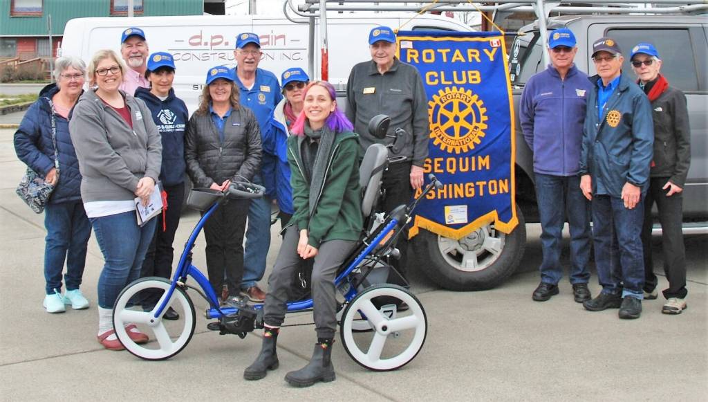 Submitted photo / Sequim Noon Rotary members present an adaptive tricycle to representatives from Camp Beausite Northwest last week. Pictured, from left, are Rotarian Judy Shanks; Camp Beausite Northwests executive director Raina Baker; Rotarians Stuart Dille, Mary Budke, Anna Richmond, Ted Shanks and Margot Hewitt; camp community development coordinator Tinna Barnet, and Rotarians Ren Garypie, Don Sorensen, Bob Macaulay and Kelly Macaulay.