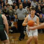 Sequims Keenan Green, right, lines up a 3-pointer in the first half of the Wolves 60-57 win over Port Angeles on Feb. 2. Green led the team with 13 points.
