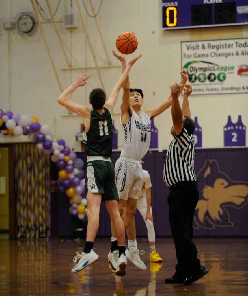 Sequim Gazette photo by Michael Dashiell / Sequims Isaiah Moore, right, and Port Angeles Dallas Dunning tip off a Feb. 2 Olympic League game. Sequim won, 60-57.