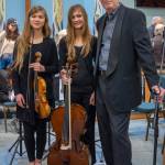 Sequim Gazette photo by Emily Matthiessen
Guest musicians Eliana and Claire Montgomery of Quilcene join Sequim Community Orchestra conductor Phil Morgan-Ellis at a Feb. 11 concert in Sequim. See more photos from the concert at sequimgazette.com.
