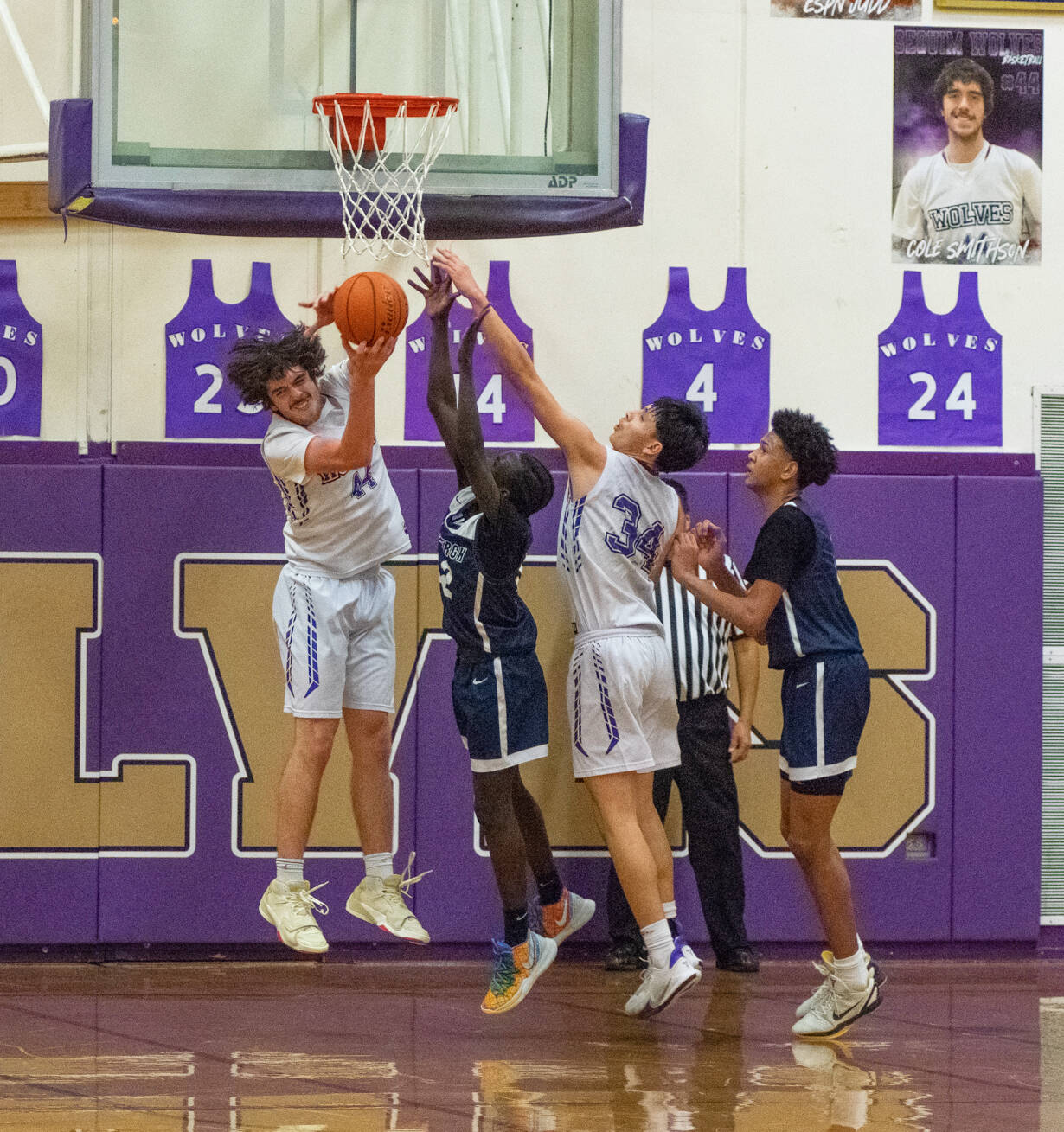 Sequim Gazette photo by Emily Matthiessen / Sequims Cole Smithson, left, snags a rebound with help from teammate Isaiah Moore in the Wolves 66-37 West Central District tourney playoff win over visiting Lindbergh on Feb. 15.