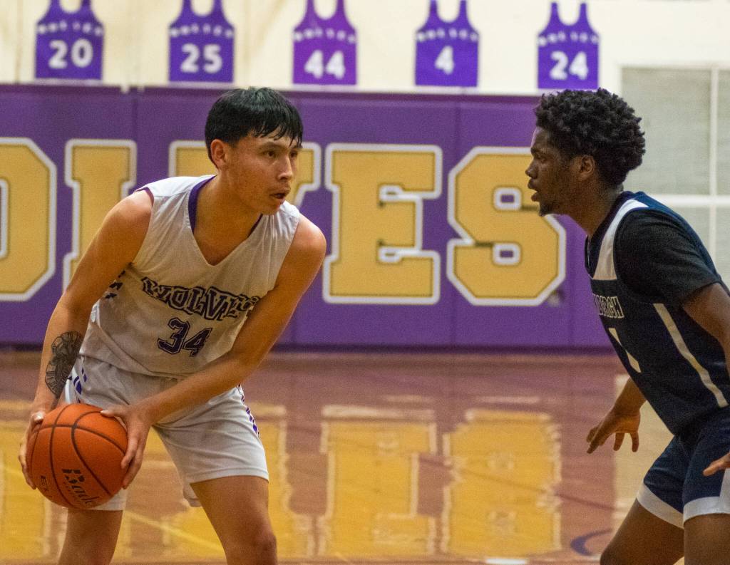 Sequim Gazette photo by Emily Matthiessen / Sequims Isaiah Moore, left, looks to score as Lindberghs Gabriel Thomas defends in a West Central District tournament game on Feb. 15 in Sequim. Moores Wolves won, 66-37.