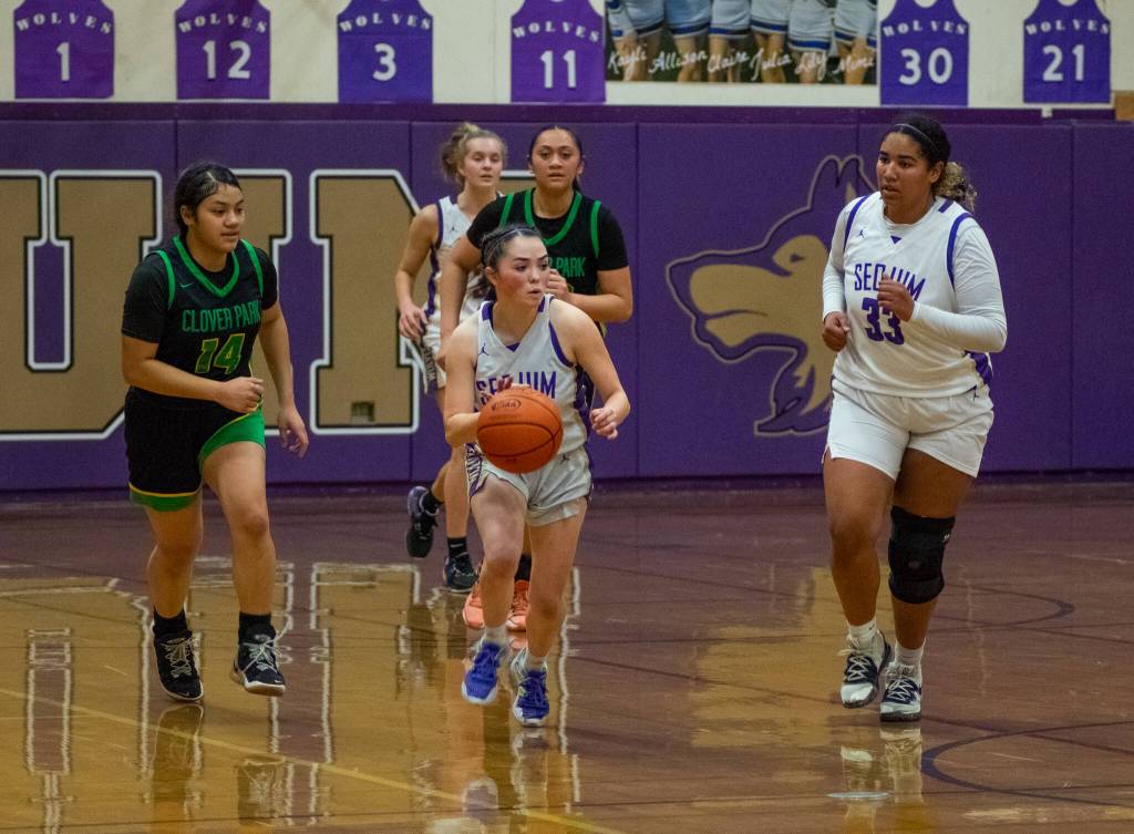 Sequim Gazette photo by Emily Matthiessen / Sequim guard Hannah Bates, center, and teammate Jelissa Julmist go on the offensive as Clover Parks Marlene Iafeta pursues, in the Wolves 65-29 district tourney-opening win at home on Feb. 14. Bates led the team with 15 points and Julmist added 13.