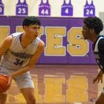 Sequim Gazette photo by Emily Matthiessen / Sequims Isaiah Moore, left, looks to score as Lindberghs Gabriel Thomas defends in a West Central District tournament game on Feb. 15 in Sequim. Moores Wolves won, 66-37.