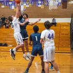Sequim Gazette photo by Emily Matthiessen / Lindberghs James Huff looks to block a shot by Sequims Lars Wiker in Sequims 66-37 West Central District playoff win on Feb. 15. Looking on are Sequims Cole Smithson, right, and Lindberghs Gabriel Thomas.