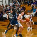 Sequim Gazette photo by Emily Matthiessen / Sequim guard Zack Thompson, right, drives past Lindberghs John Chuol in a Feb. 15 West Central District tournament game. Sequim ended Lindberghs season with a 66-37 victory.