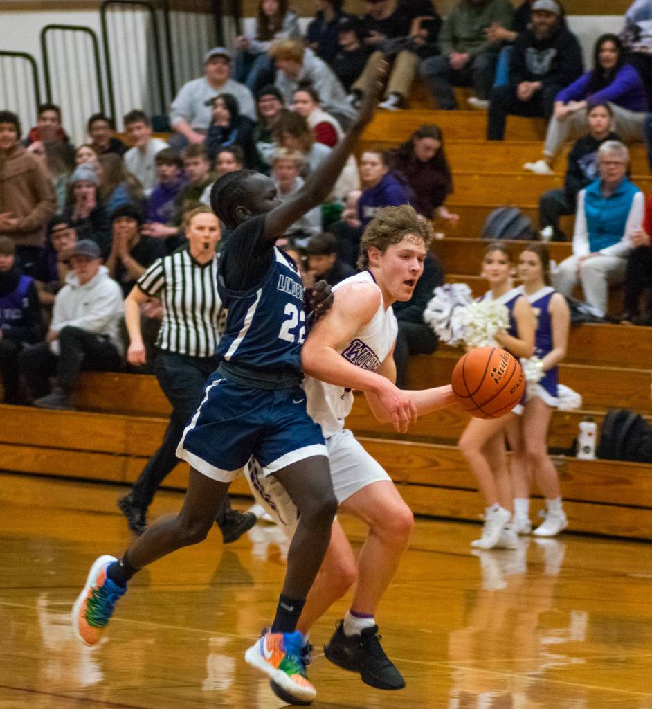 Sequim Gazette photo by Emily Matthiessen / Sequim guard Zack Thompson, right, drives past Lindberghs John Chuol in a Feb. 15 West Central District tournament game. Sequim ended Lindberghs season with a 66-37 victory.