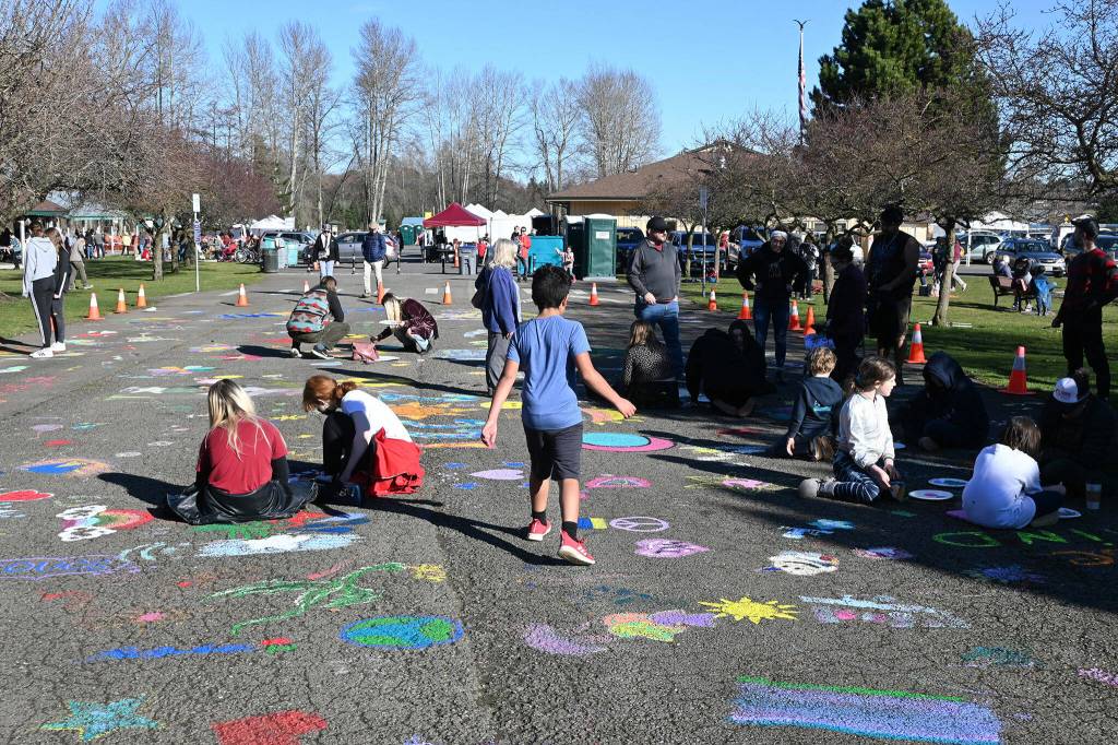 Sequim Gazette photo by Michael Dashiell/ Visitors to Carrie Blake Community Park on March 4 are invited to use provided paint and brushes to make designs that will last the year as part of the Sequim Sunshine Festivals street mural project.