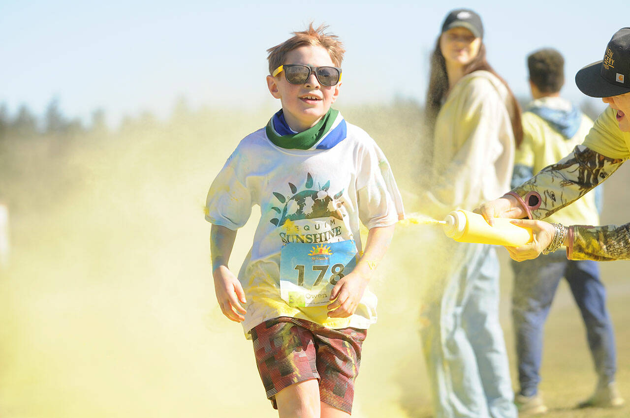Sequim Gazette photo by Michael Dashiell
Owen DeAngelo grins as he gets a touch of yellow at the last color station at the Sun Fun Color Run 5K in 2022 at the Albert Haller Playfields just north of Carrie Blake Community Park. Entries remain open for the 1K and 5K run/walk races on March 4.