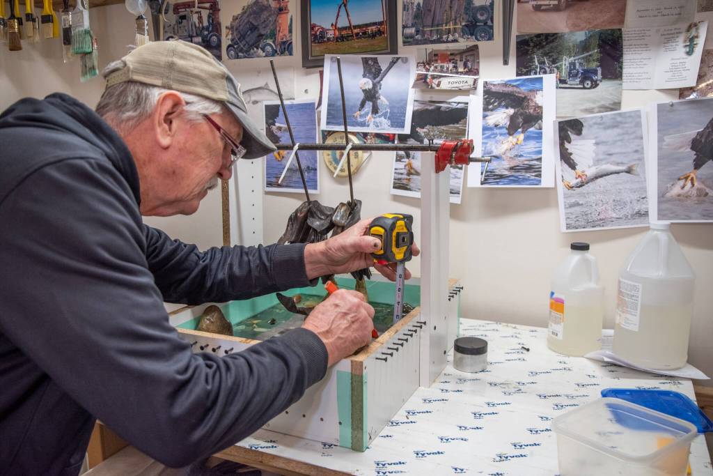 Sequim Gazette photo by Emily Matthiessen
Molly Omanns mentor, Don Meyer, measures for the next epoxy pour. The pair pour an inch at a time, waiting 24 hours for the layer to dry before pouring another layer.
