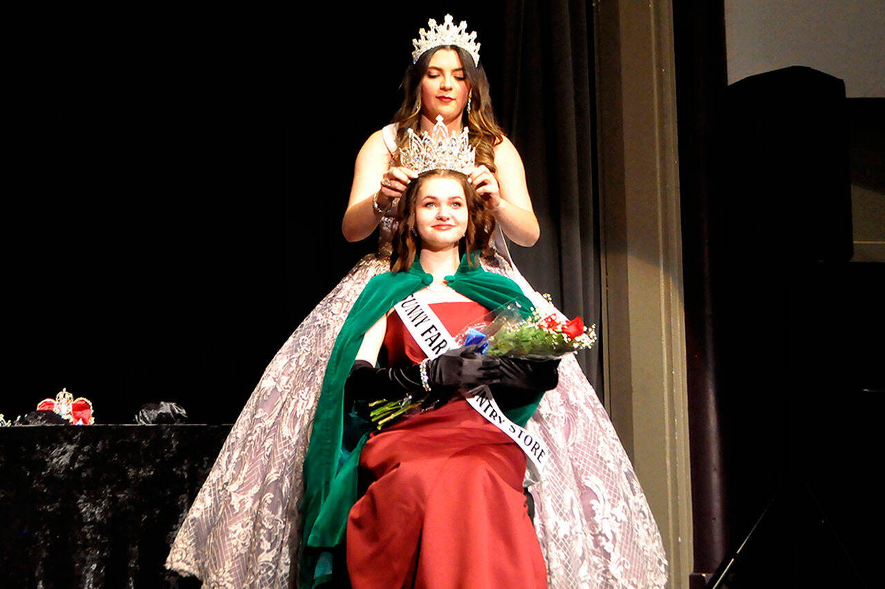 Sequim Gazette photo by Matthew Nash
This years Sequim Irrigation Festival queen, Pepper Reymond, is crowned on Feb. 25 by 2022 festival queen Isabella Williams. Reymond is joined on the festivals royal court by princess Anne Marie Barni, prince Fred Cameron, and princess Paige Skylar Krzyworz. Their parade float will be revealed just prior to the Kick-Off Dinner and Auction on March 25 at 7 Cedars Casino. See story and more photos, A-2.