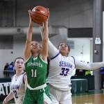Photo by Jim Heintz / Sequim's Jelissa Julmist (33) and Sammie Bacon and Tumwater's Kylie Waltermeyer vie for the ball in the Wolves' 38-24 win over Tumwater at the class 2 A state tournament on March 3.