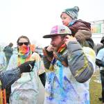 Sequim Gazette photos by Michael Dashiell
Artem Cummings, nearly 3, gets a piggyback ride from dad Dillon Cummings as mom Shelbie looks on, following the Sun Fun Color Run on March 4. The Cummings were part of a large family contingent who braved the chilly weather and rain/sleet/snow for the race.