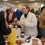 Sequim Gazette photo by Michael Dashiell / Meg and Buddy Depew chat with customers at the Sunshine Market inside the Guy Cole Event Center on March 4.