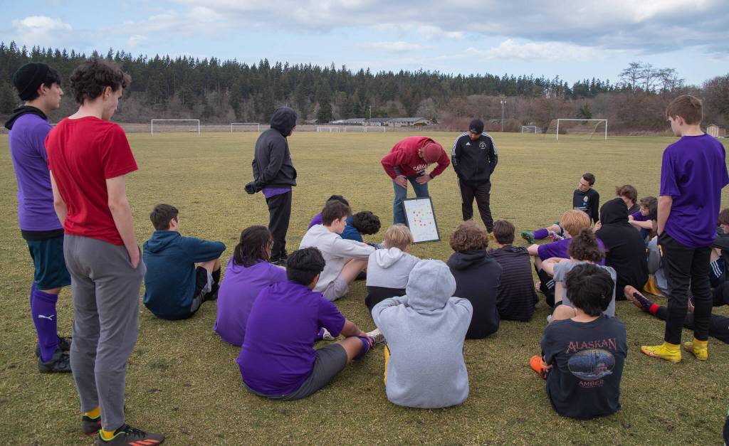 Sequim Gazette photo by Emily Matthiessen / From left, junior varsity coach Dave Breckenridge, and assistant coaches Jared King and Javier Gomez lay out a practice plan for the junior varsity soccer team.