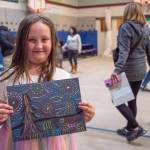 Sequim Gazette photo by Emily Matthiessen / Katelyn Williams, fourth grade student, shares her replication of Van Goghs Starry Night at Greywolf Elementarys Meet the Masters Art Show. She said, Im really proud of it because it shows I how I like Meet the Masters. She added that she made another one at home.
