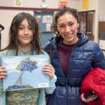 Sequim Gazette photo by Emily Matthiessen / Elena Carroll, 4th grade, shares her Monet inspired art piece with her mother, Jessie Carroll. I love it, she said, about the Meet the Masters class she attended for eight weeks after school. Her parents said the were happy to see the school put this program together, exposing her to some historic artists was a great benefit for a child who has always had an affinity for art.