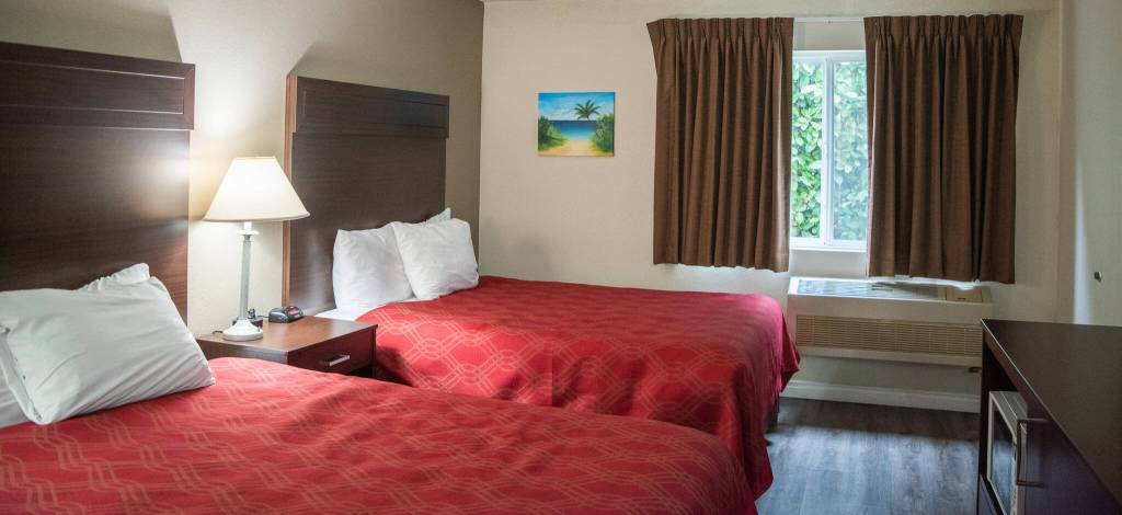 Sequim Gazette photo by Emily Matthiessen / A two queen bed room at the Ocean Star Inn features original art by Anna Oh, refrigerator, microwave and coffee maker. Until this February, Ocean Star was an EconoLodge and now it is an independent motel, with significant updates in the last three years, including all flooring and furniture replaced.