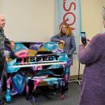 Sequim Gazette photo by Matthew Nash/ Tama Bankston, KSQM volunteer coordinator, readies to snap a photo of Rich and Lindzee Langsford, who recently donated the Respect piano they purchased from Jennifer Hudsons Julian D. King Gift Foundation at a benefit auction. The radio station starts a series of public mini-concerts on March 25