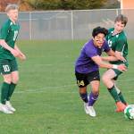 Photo by Keith Thorpe, Olympic Peninsula News Group/ Sequims Evan Cisneros, center, pushes past Port Angeles Jacob Weaver, right, as Weavers teammate, Matthew Miller, looks on at left on March 16 in Port Angeles.