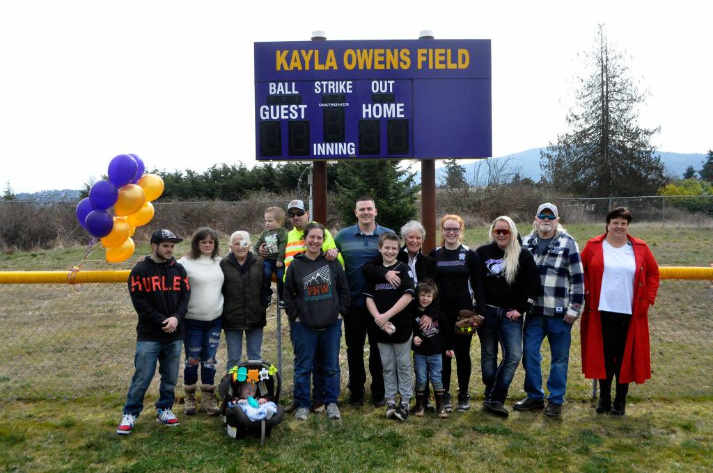 Sequim Gazette photo by Matthew Nash/ Family members of Kayla Owens gather for a photo after a Sequim Little League ceremony dedicating the new Kayla Owens Field on March 19.