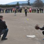 Sequim Gazette photo by Matthew Nash/ Liam, 11, and Nevaeh Owens, 14, throw out ceremonial pitches caught by their dad Cody Owens and friend Lucy Spelker at a dedication ceremony naming a field after their mom Kayla Owens on March 19 at the Sequim Little Leagues James Standard Park.