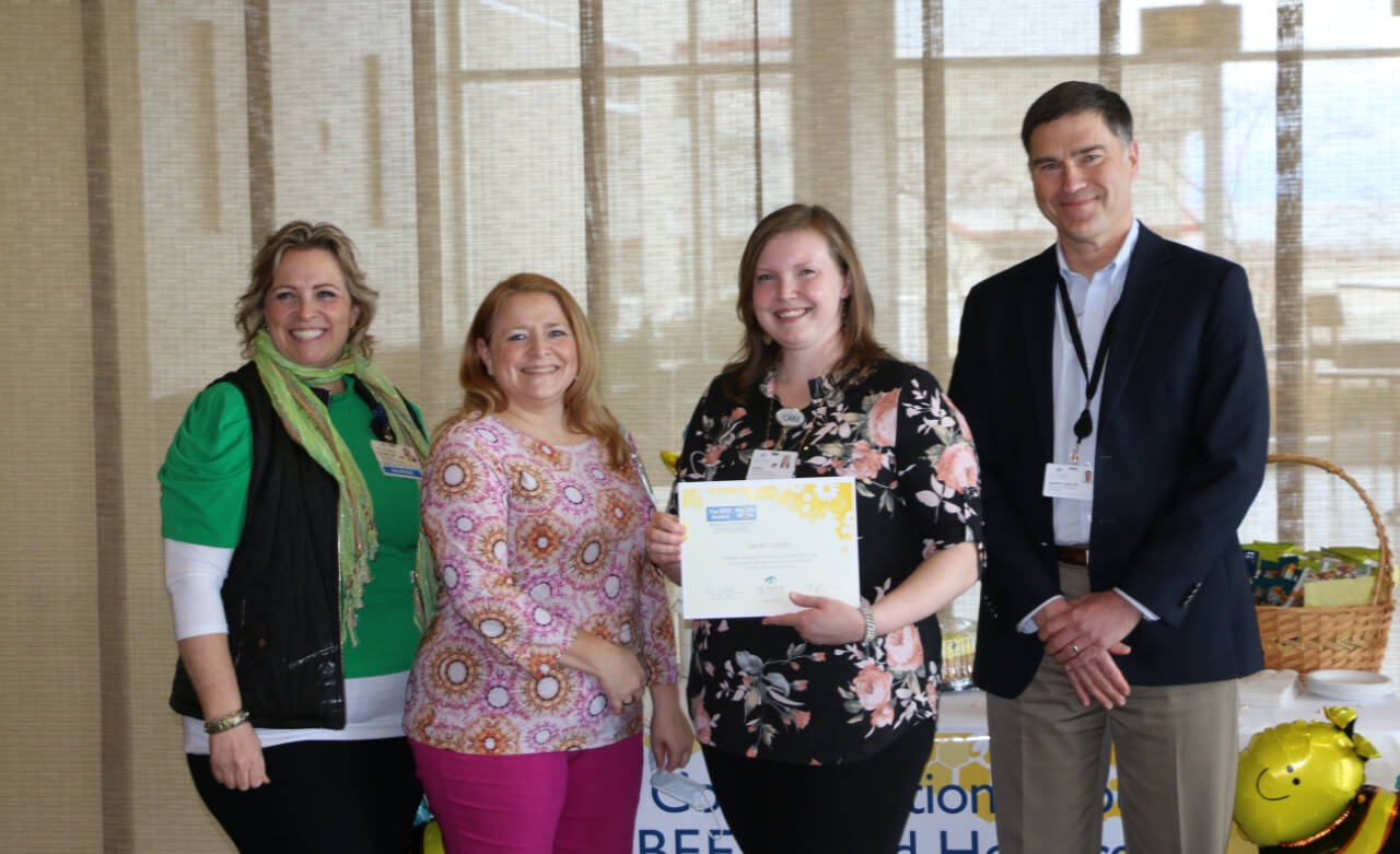 Photo courtesy of Olympic Medical Center / Sarah Lester, a Home Health administrative assistant for Olympic Medical Center (third from left), accepts her OMC BEE (Being Excellent Every Day) award. Pictured, from left, are: RN Deanna Thurston, Home Health Clinical Manager; RN Joni Morgan, Home Health Clinical Manager; Lester, and Darryl Wolfe, Olympic Medical Center Chief Executive Officer.