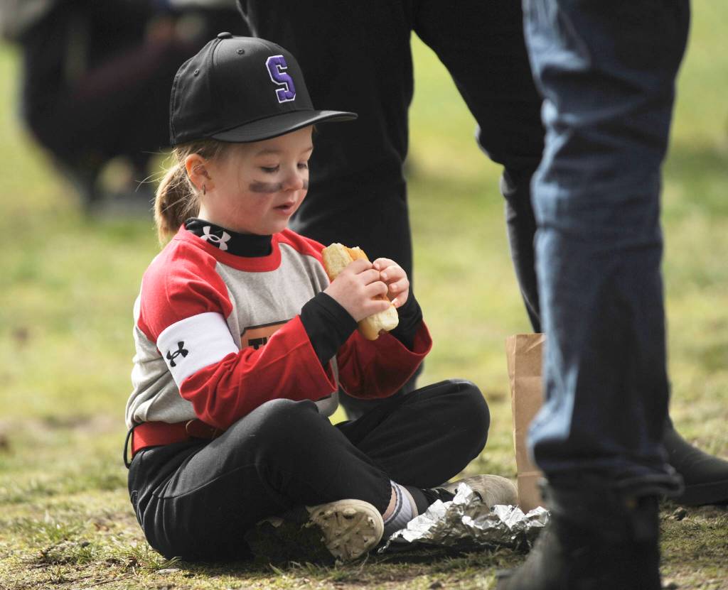 Lachlynn Henning, 5, enjoys a hot dog lunch at the Sequim Little League Opening Day ceremonies on March 25. Sponsored by Clallam County Professional Firefighters IAFF Local 2933, the event included free hot dog lunches for players and coaches.
