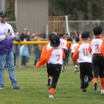 Sequim Little League president Nick Simpson is all smiles during a player parade at the leagues Opening Day ceremony on March 25.