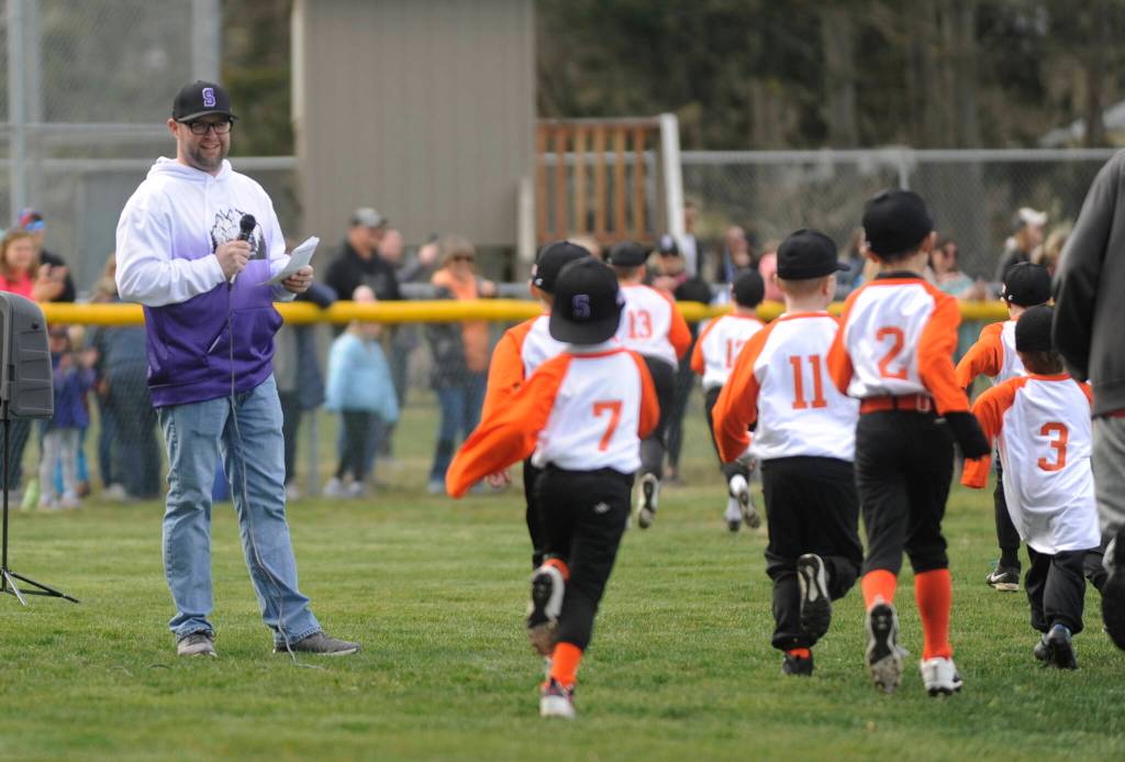 Sequim Little League president Nick Simpson is all smiles during a player parade at the leagues Opening Day ceremony on March 25.
