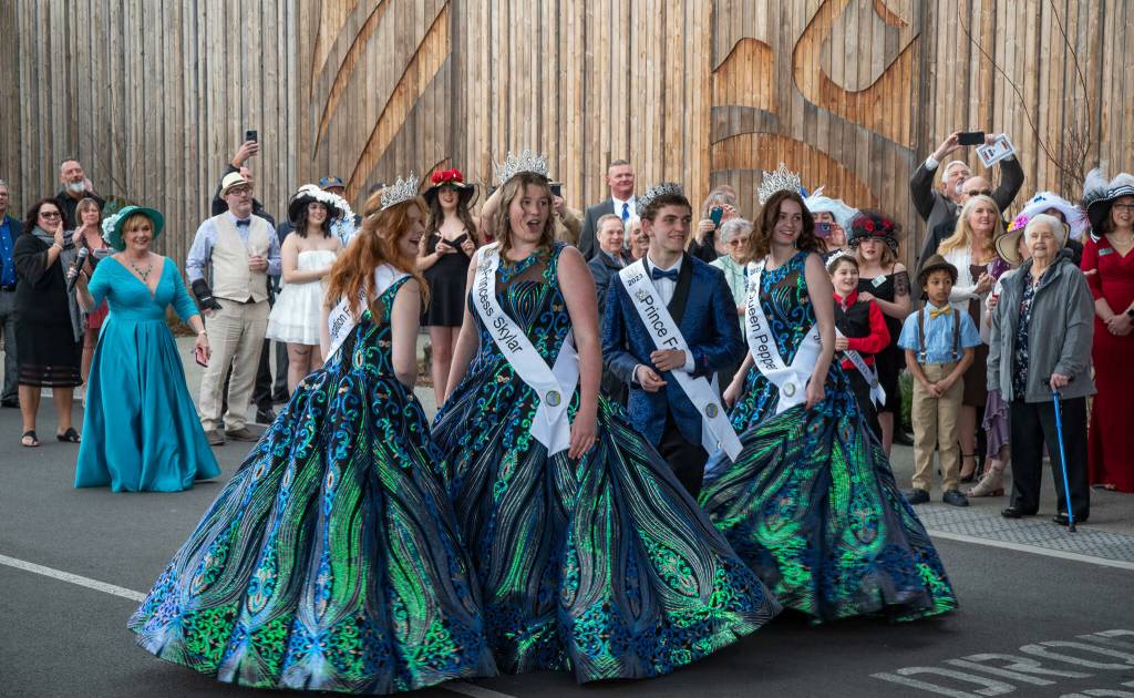 Sequim Gazette photo by Emily Matthiessen / Princess Anne Marie Barni, Princess Skylar Kryzworz, Prince Fred Cameron, and Queen Pepper Reymond react as they see their float for the first time at the kick-off dinner and auction for the Irrigation Festival at the 7 Cedars Resort on March 25.