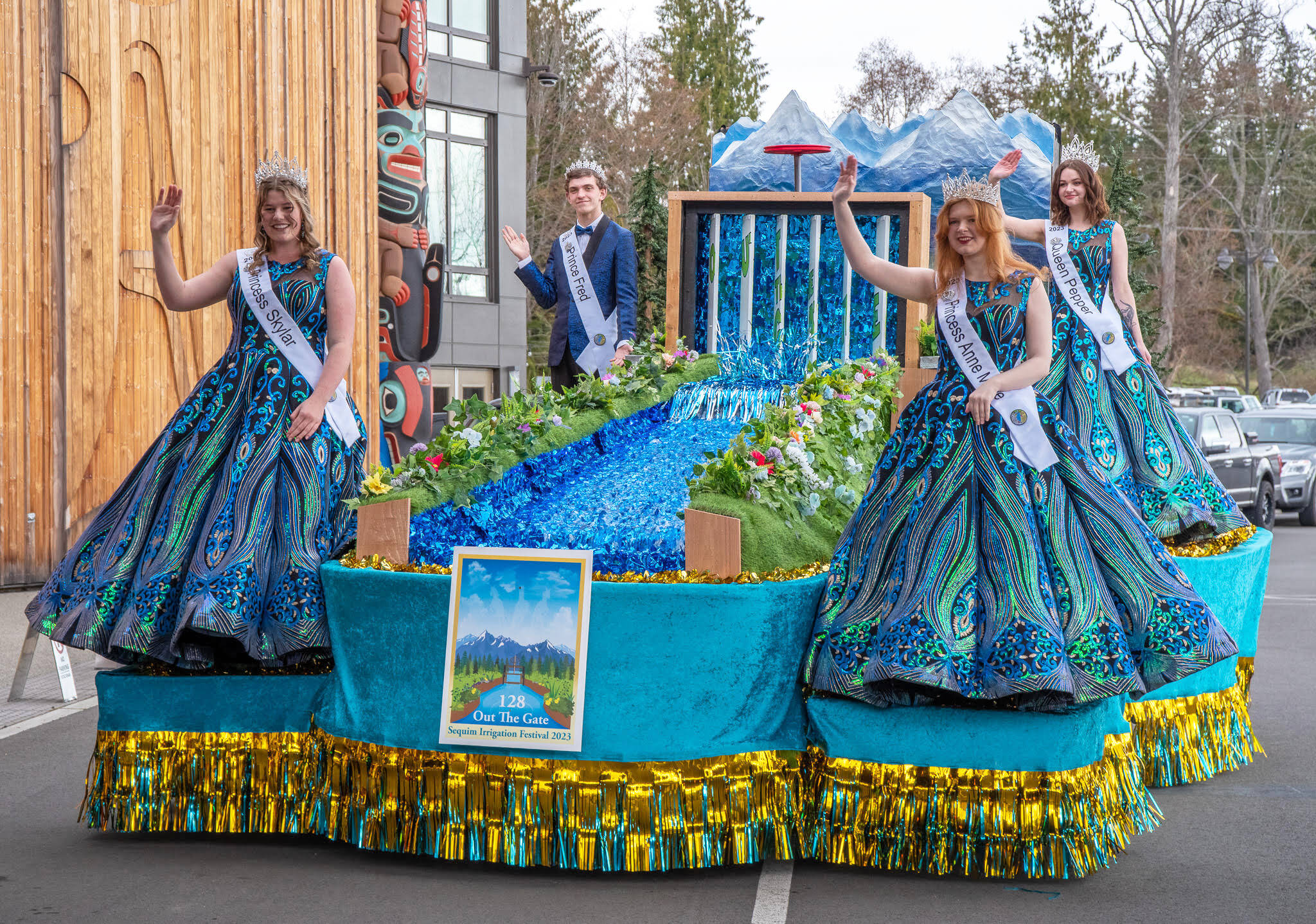 Sequim Gazette photo by Emily Matthiessen / Princess Skylar Kryzworz, Prince Fred Cameron, Princess Anne Marie Barni and Queen Pepper Reymond try out their float for the first time at the kick-off dinner and auction for the Irrigation Festival at the 7 Cedars Resort on March 25. The float features a changing sign, and real flowing water.