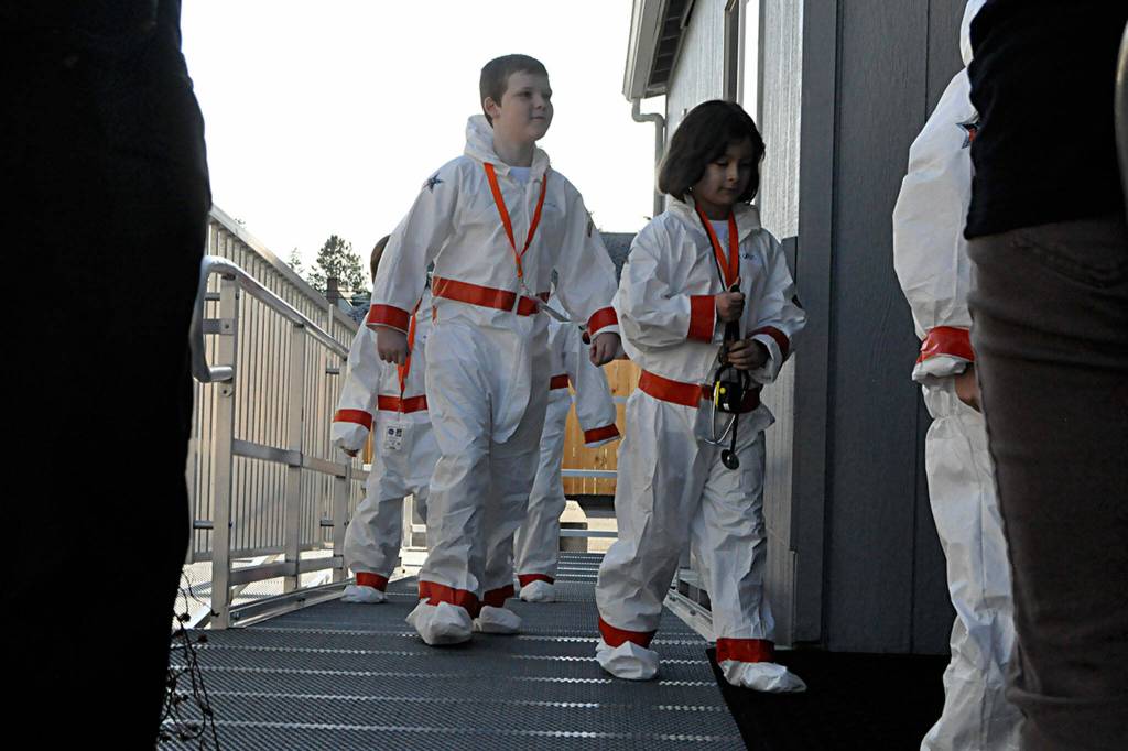 Sequim Gazette photo by Matthew Nash/ Third graders Vaughn McCarter and Eden Kulfan enter their spaceship (Michele Canepas classroom at Olympic Peninsula Academy) before they go on a mission to Mars on March 27.