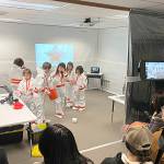 Sequim Gazette photo by Matthew Nash/ Family members watch as third graders in Michele Canepas class begin a soft landing exercise for their spaceship by building egg drop devices.