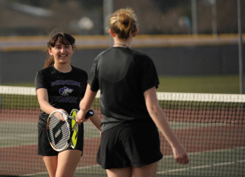 Sequim Gazette photo by Michael Dashiell / Sequims Amara Gonzalez and Payton Smithson congratulate each other after winning a point in their No. 2 doubles match against Port Angeles Kayla Jones and Bridget Weed on March 29. Gonzalez and Smithson won their match, 6-3 and 6-1.