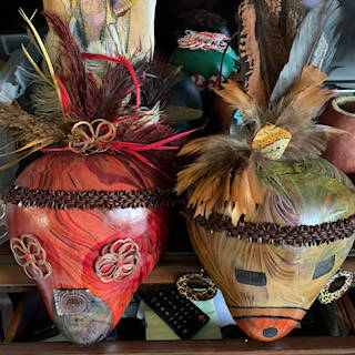 Masks by Jane Smith, a featured artist at the Blue Whole Gallerys May 2023, exhibition, May Flowers.