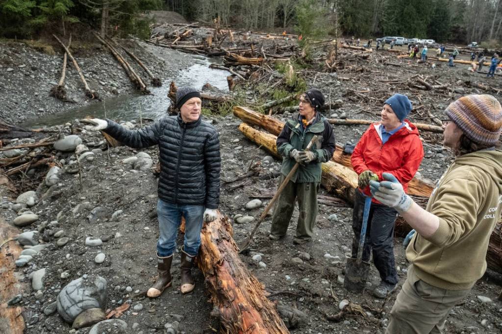 Photo by Charles Espey/North Olympic Salmon Coalition. Volunteers with the North Olympic Salmon Coalition gather to learn about the Caldero Side Channel Project. The coalition hosts a mulching party at April 22.