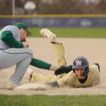 Sequim Gazette photoS by Michael Dashiell
Port Angeles first baseman Ezra Townsend, left, looks to put the tag on Sequim baserunner Toppy Robideau in the second inning of an April 13 league match-up in Sequim. Port Angeles won 12-2 in five innings.