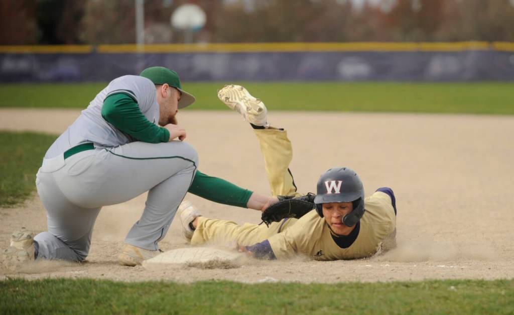 Sequim Gazette photoS by Michael Dashiell
Port Angeles first baseman Ezra Townsend, left, looks to put the tag on Sequim baserunner Toppy Robideau in the second inning of an April 13 league match-up in Sequim. Port Angeles won 12-2 in five innings.