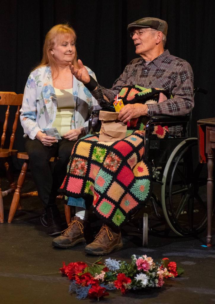 Sequim Gazette photo by Emily Matthiessen / Cheryl DiPietro and Ken Burland, playing married couple Annie and John in OTAs newest production Calendar Girls, share a private moment on the eve of his passing.
