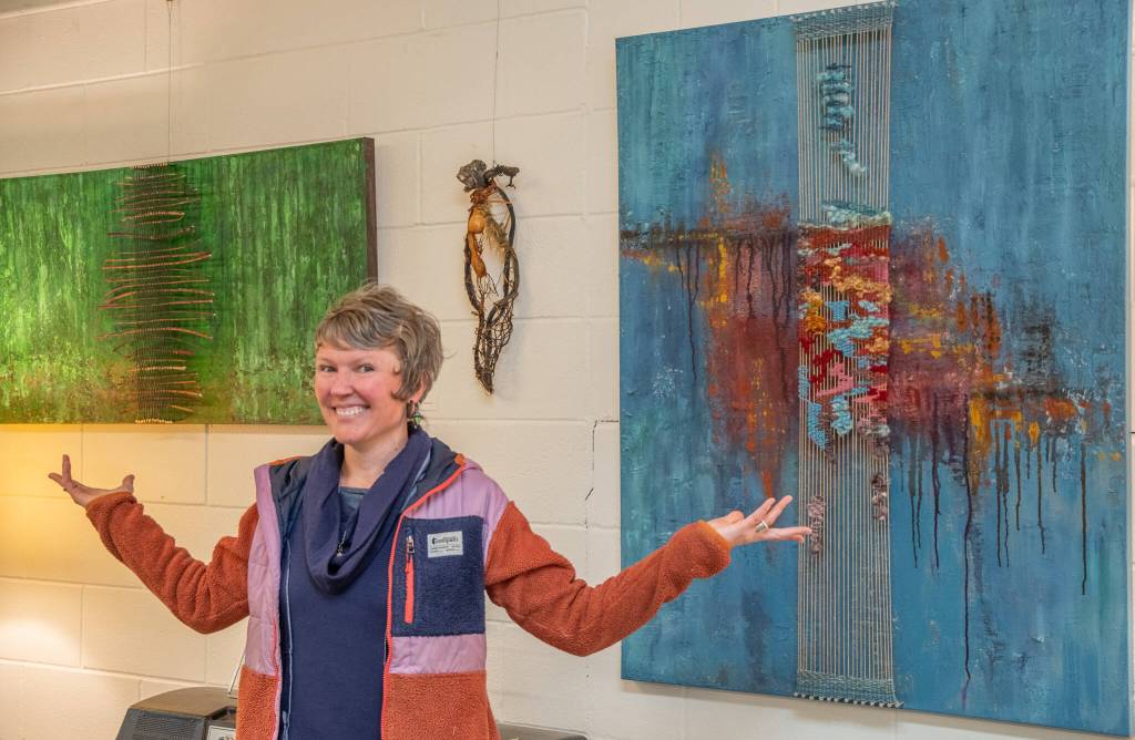 Sequim Gazette photoS by Emily Matthiessen
The work of local fiber/multimedia artist Emily Carlquist is featured at Dandelion Botanical Company for the month of April. Carlquist stands between a couple of her large pieces with a kelp sculpture behind.